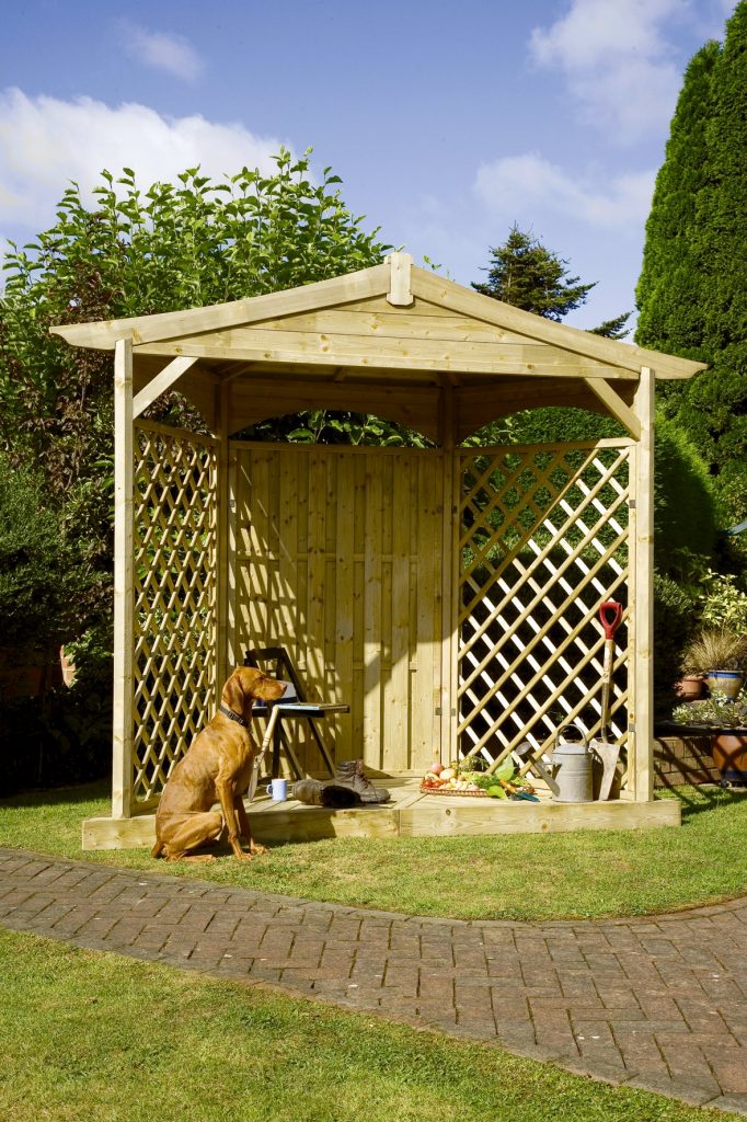 Dog sat outside a wooden gazebo